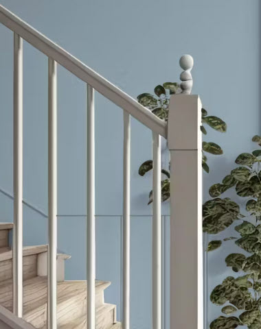 Stair bannister with blue wall background