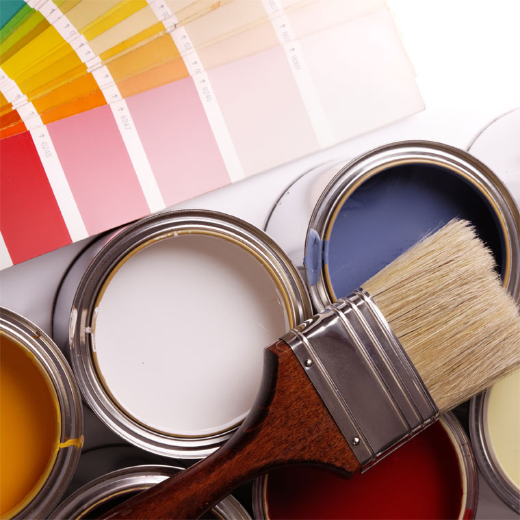 Collection of open paint tins and a paint brush